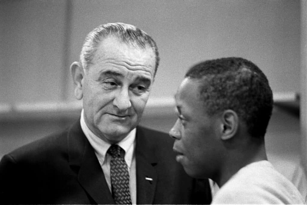 President Lyndon B. Johnson talks to corpsmen at Catoctin Job Corps Conservation Center, March 10, 1965. Photograph by Yoichi Okamoto. Source: LBJ Library. 