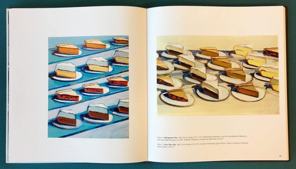 Photo of internal catalogue spread featuring paintings by Wayne Thiebaud