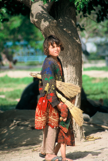 Fig. 4: Two small girls sweep sidewalks in Kabul.